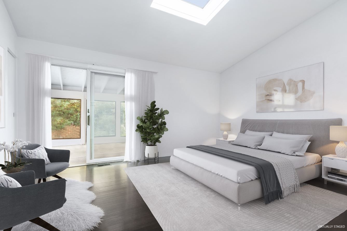 132 Springy Banks Road East Hampton, NY 11937 - Photo 19 of 35 a spacious bedroom with a large bed and a couch