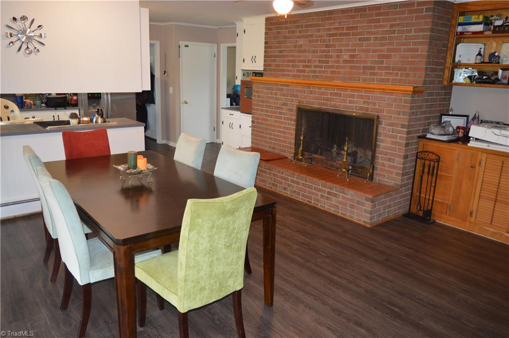 402 Springwood Road Asheboro, NC 27205 - Photo 6 of 21 Dining has a fireplace and additional storage.