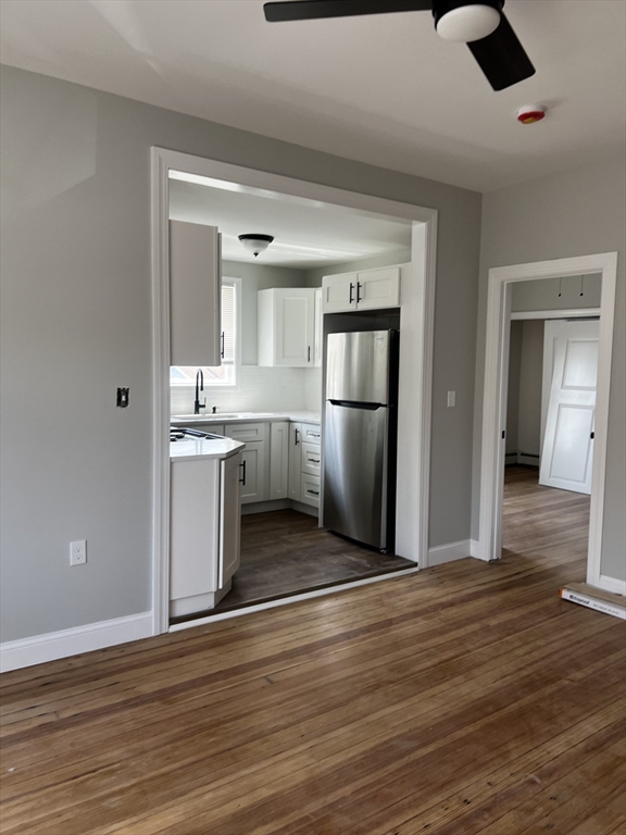 2039 Pleasant Street, Unit 2 Fall River, MA 02723 - Photo 2 of 10 a view of kitchen with cabinets and wooden floor