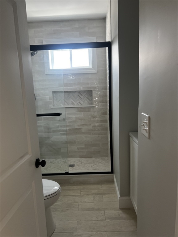 2039 Pleasant Street, Unit 2 Fall River, MA 02723 - Photo 3 of 10 a bathroom with a toilet and a shower