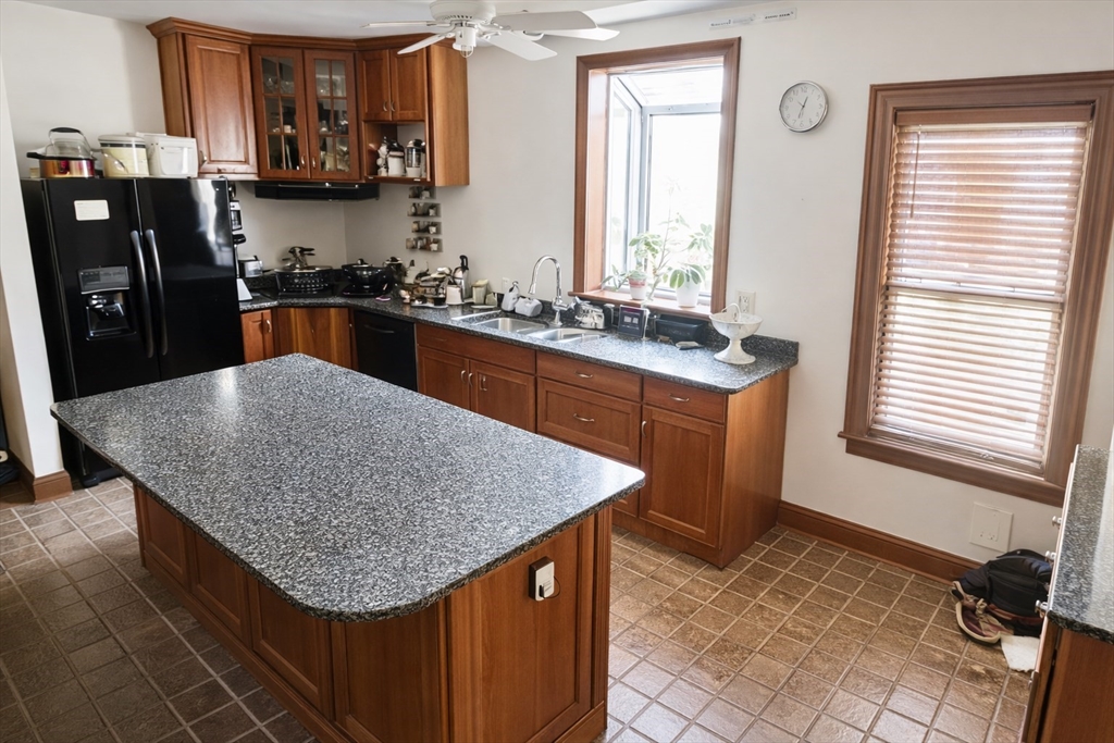 53 Hillside Street, Unit 2 Boston, MA 02120 - Photo 3 of 10 a kitchen with stainless steel appliances granite countertop a sink stove and refrigerator