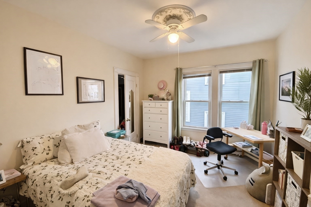53 Hillside Street, Unit 2 Boston, MA 02120 - Photo 7 of 10 a bedroom with a bed and a chandelier