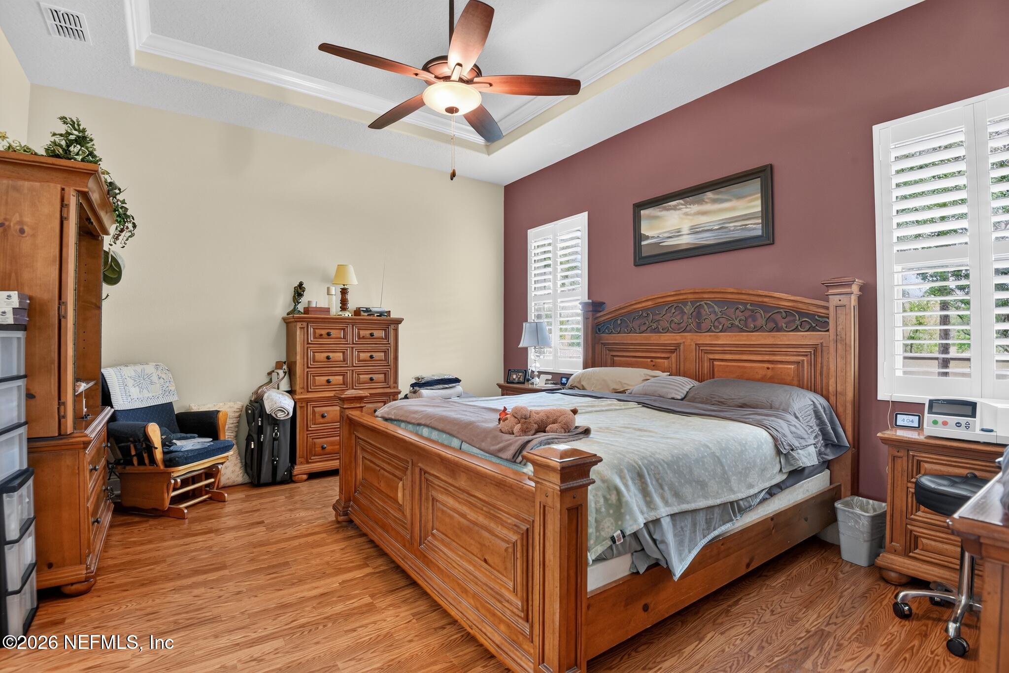 110 Vía Roma Ormond Beach, FL 32174 - Photo 20 of 43 a bedroom with a bed and a chandelier