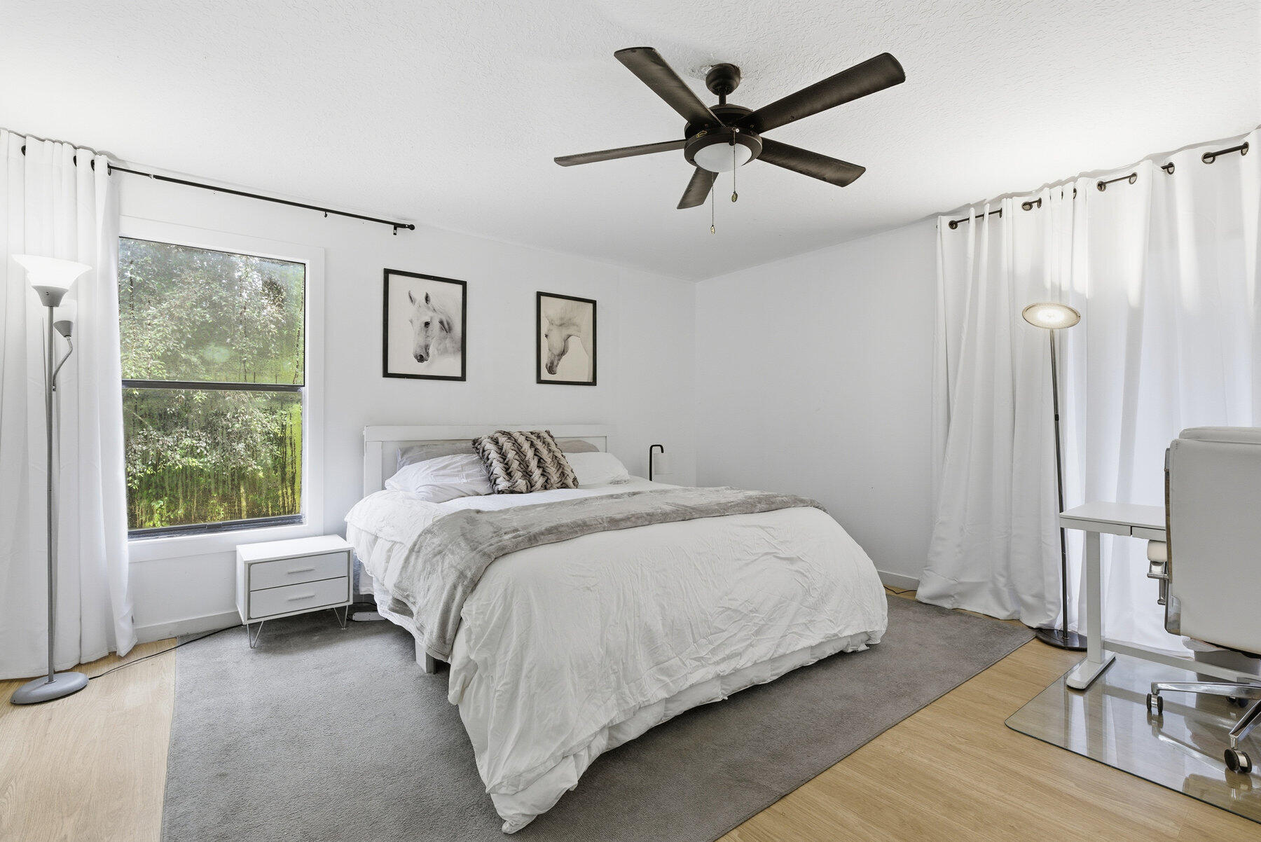 17251 38th Road North Loxahatchee, FL 33470 - Photo 12 of 35 a spacious bedroom with a bed a couch and a window