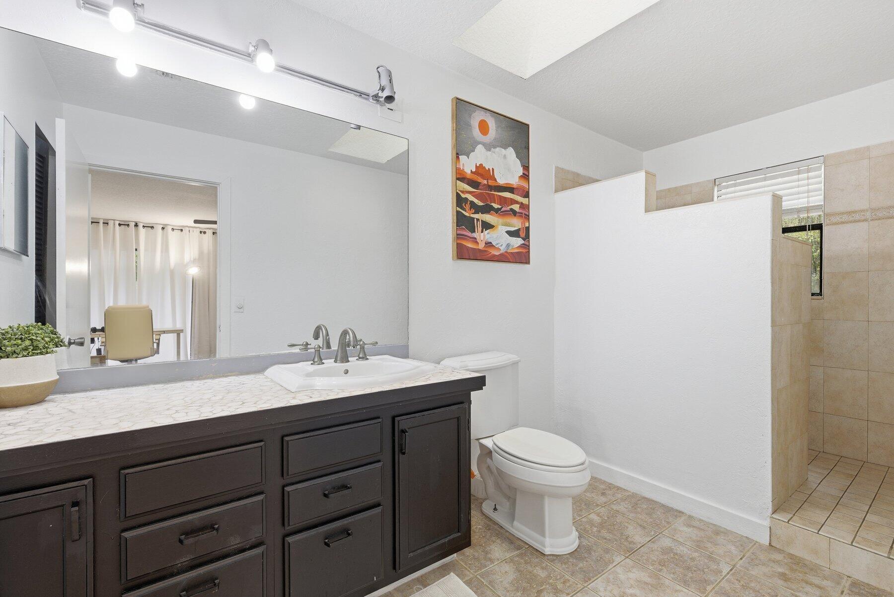 17251 38th Road North Loxahatchee, FL 33470 - Photo 14 of 35 a bathroom with a toilet sink and mirror