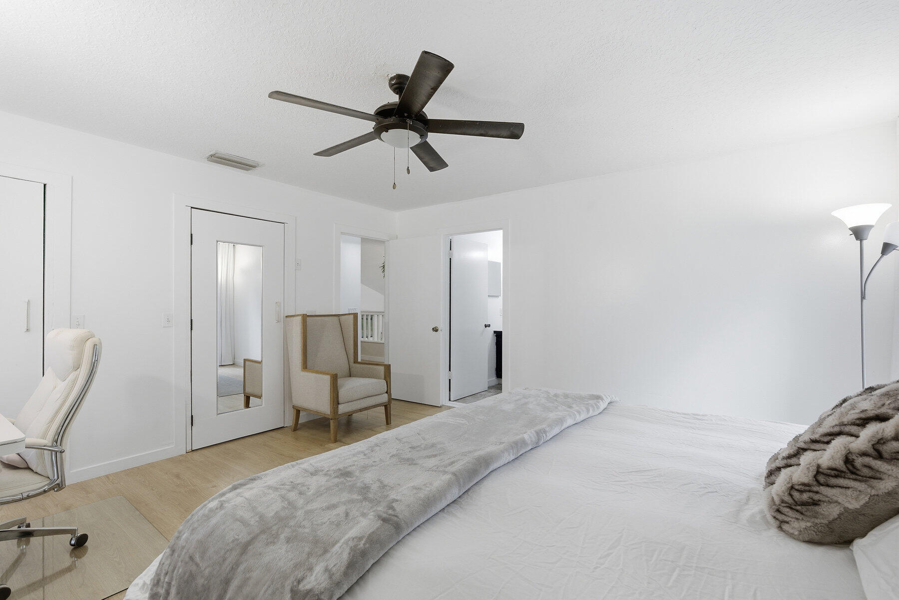 17251 38th Road North Loxahatchee, FL 33470 - Photo 15 of 35 a bedroom with a bed and a chandelier