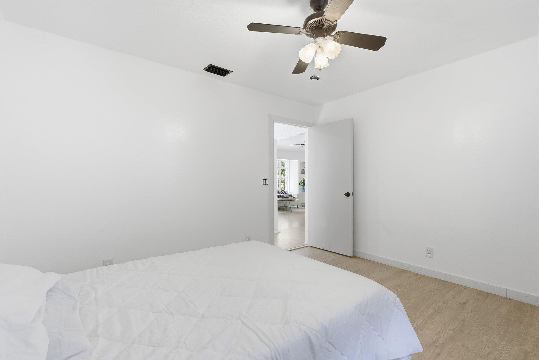 17251 38th Road North Loxahatchee, FL 33470 - Photo 18 of 35 a bedroom with a bed chandelier and a window