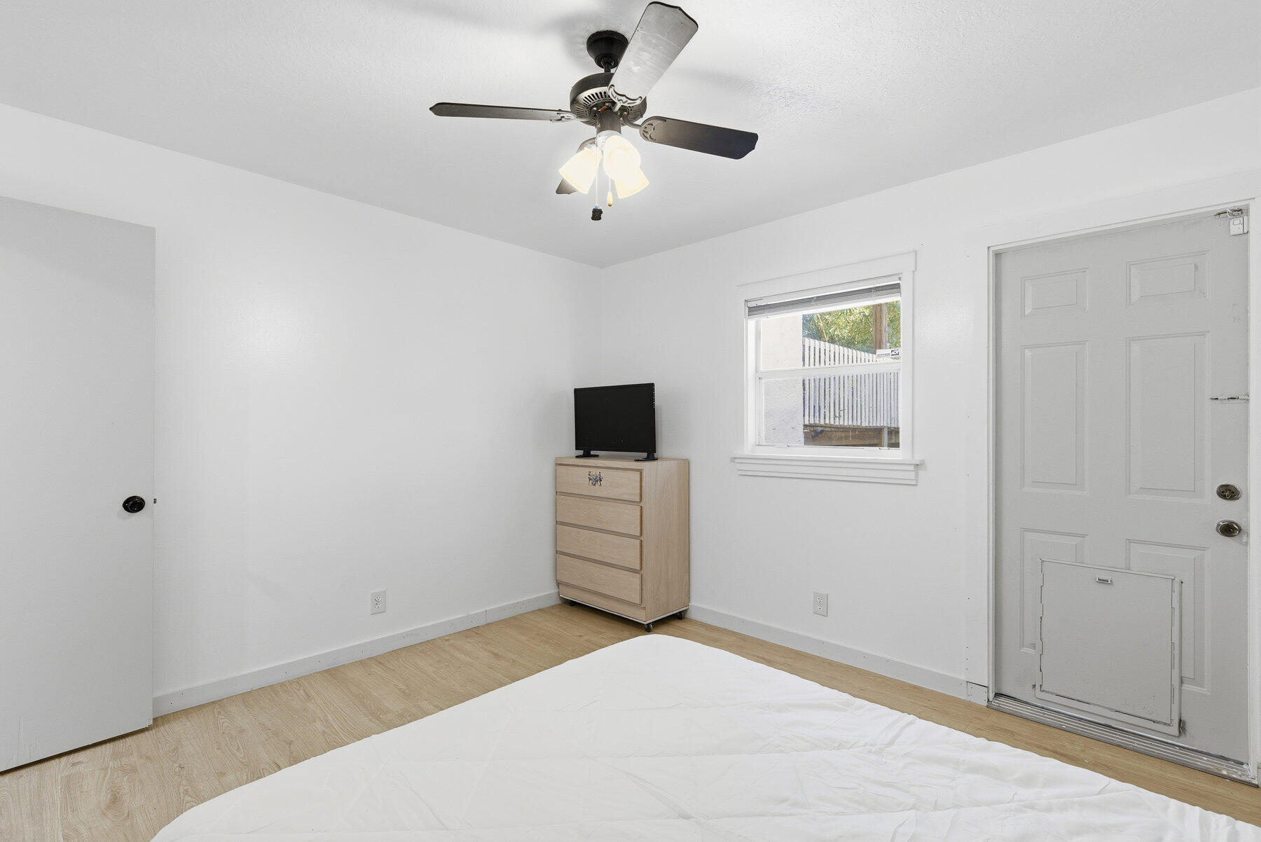 17251 38th Road North Loxahatchee, FL 33470 - Photo 19 of 35 a bedroom with a bed and a chandelier