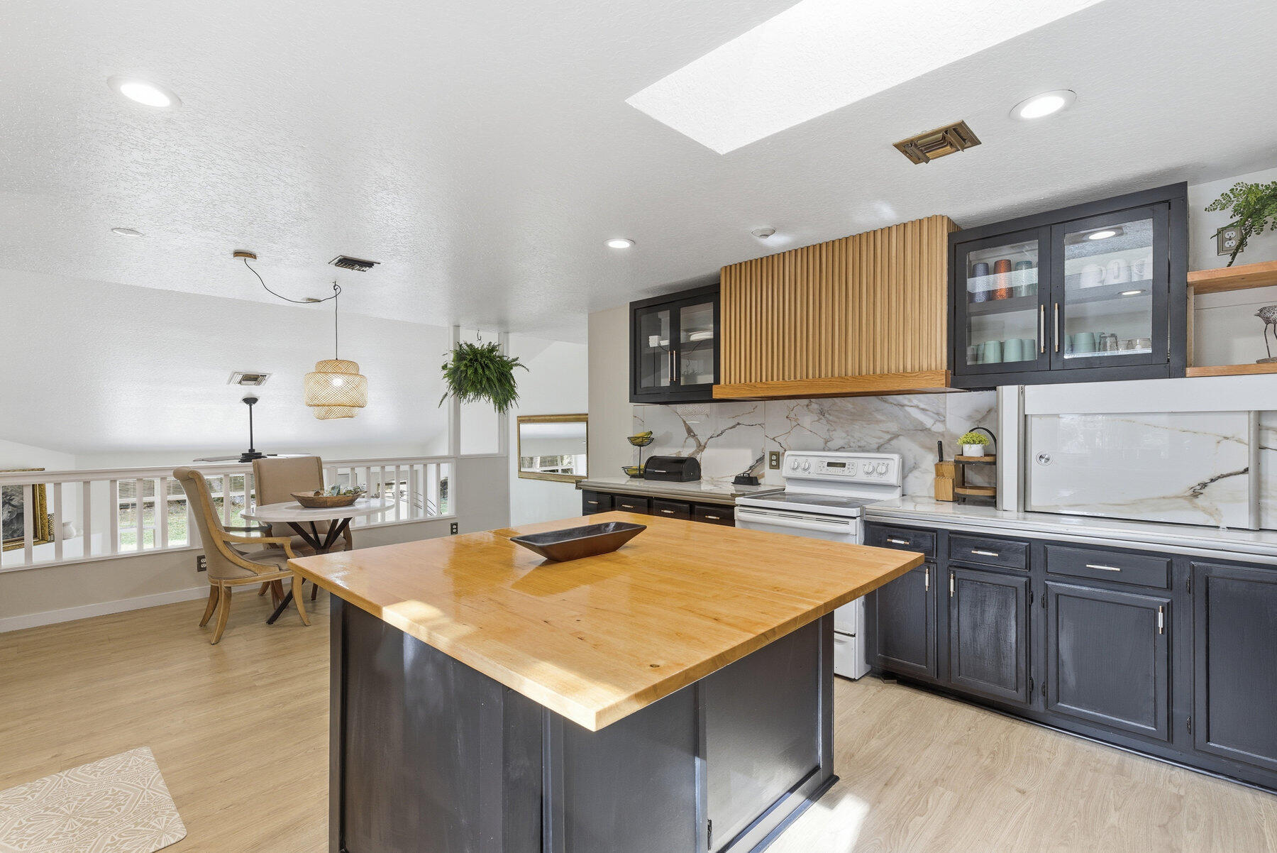 17251 38th Road North Loxahatchee, FL 33470 - Photo 9 of 35 a kitchen with a sink a counter top space and living room view