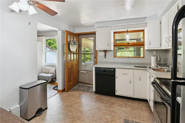 a kitchen with granite countertop a stove a sink and a refrigerator