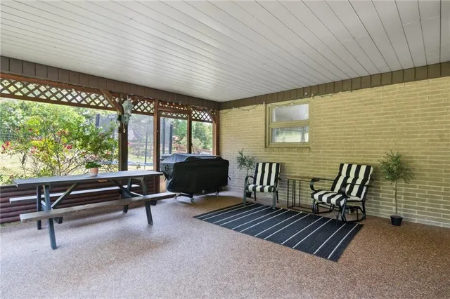 a balcony with furniture and large windows