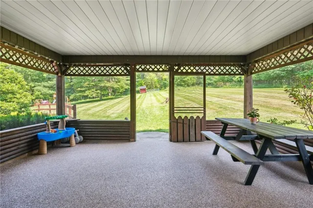 a living room with furniture and floor to ceiling windows