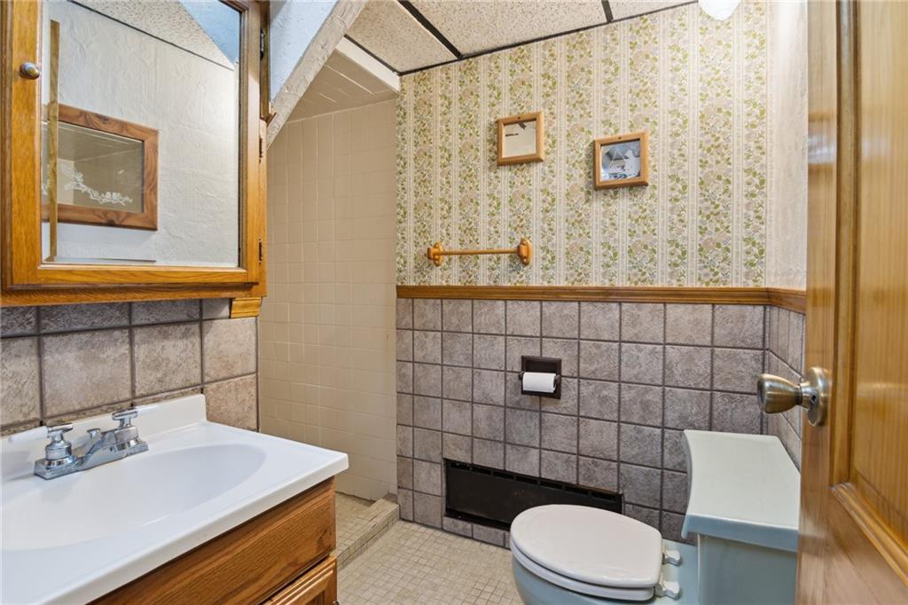 1343 Venetia Road Eighty Four, PA 15330 - Photo 23 of 27 a bathroom with a sink a toilet and a mirror