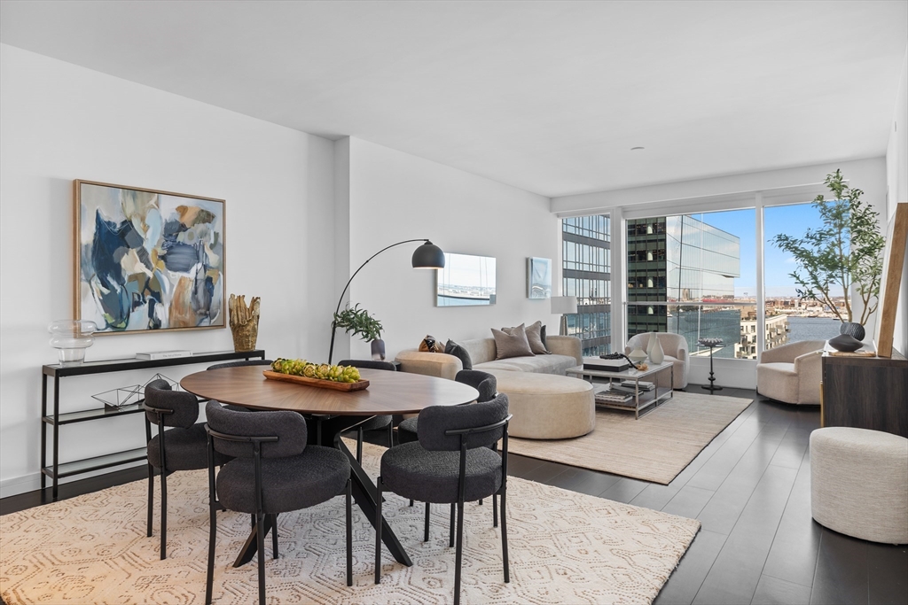 150 Seaport Boulevard, Unit 10D Boston, MA 02210 - Photo 2 of 23 a view of a dining room with furniture window and wooden floor