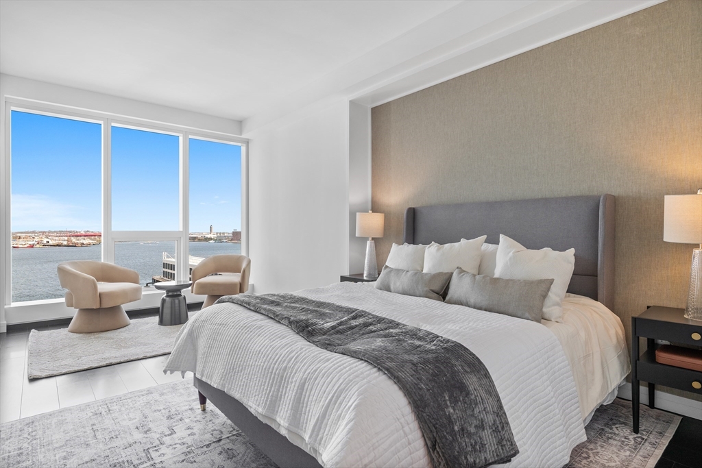 150 Seaport Boulevard, Unit 10D Boston, MA 02210 - Photo 4 of 23 a bed room with two bed and a couch