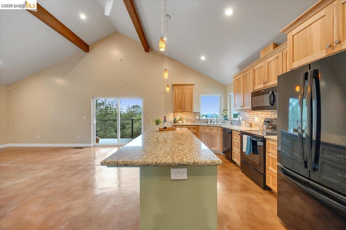 18180 Robin Ridge Road Sonora, CA 95370 - Photo 72 of 88 Kitchen featuring a granite island, light wood cabinetry, recessed lighting, and a subway tile backsplash