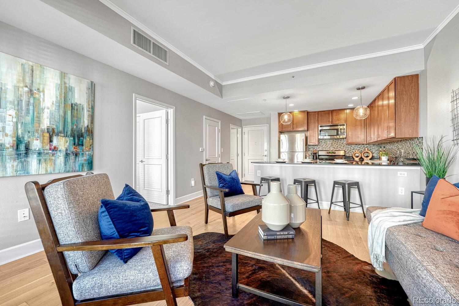 a living room with furniture and a floor to ceiling window