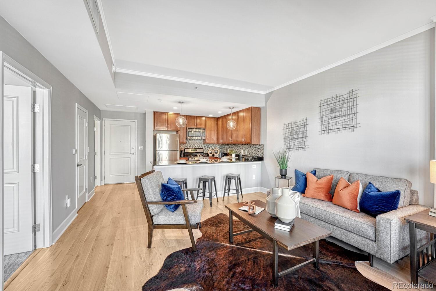 1975 Grant Street, Unit 509 Denver, CO 80203 - Photo 14 of 30 a living room with furniture and a kitchen view