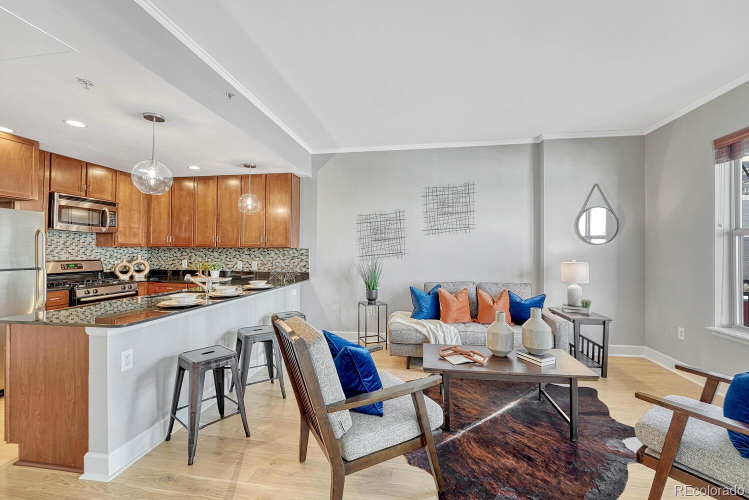 1975 Grant Street, Unit 509 Denver, CO 80203 - Photo 15 of 30 a living room with stainless steel appliances kitchen island granite countertop furniture and a view of kitchen