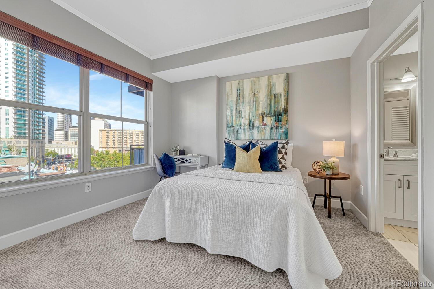 1975 Grant Street, Unit 509 Denver, CO 80203 - Photo 16 of 30 a bedroom with a bed and a large window