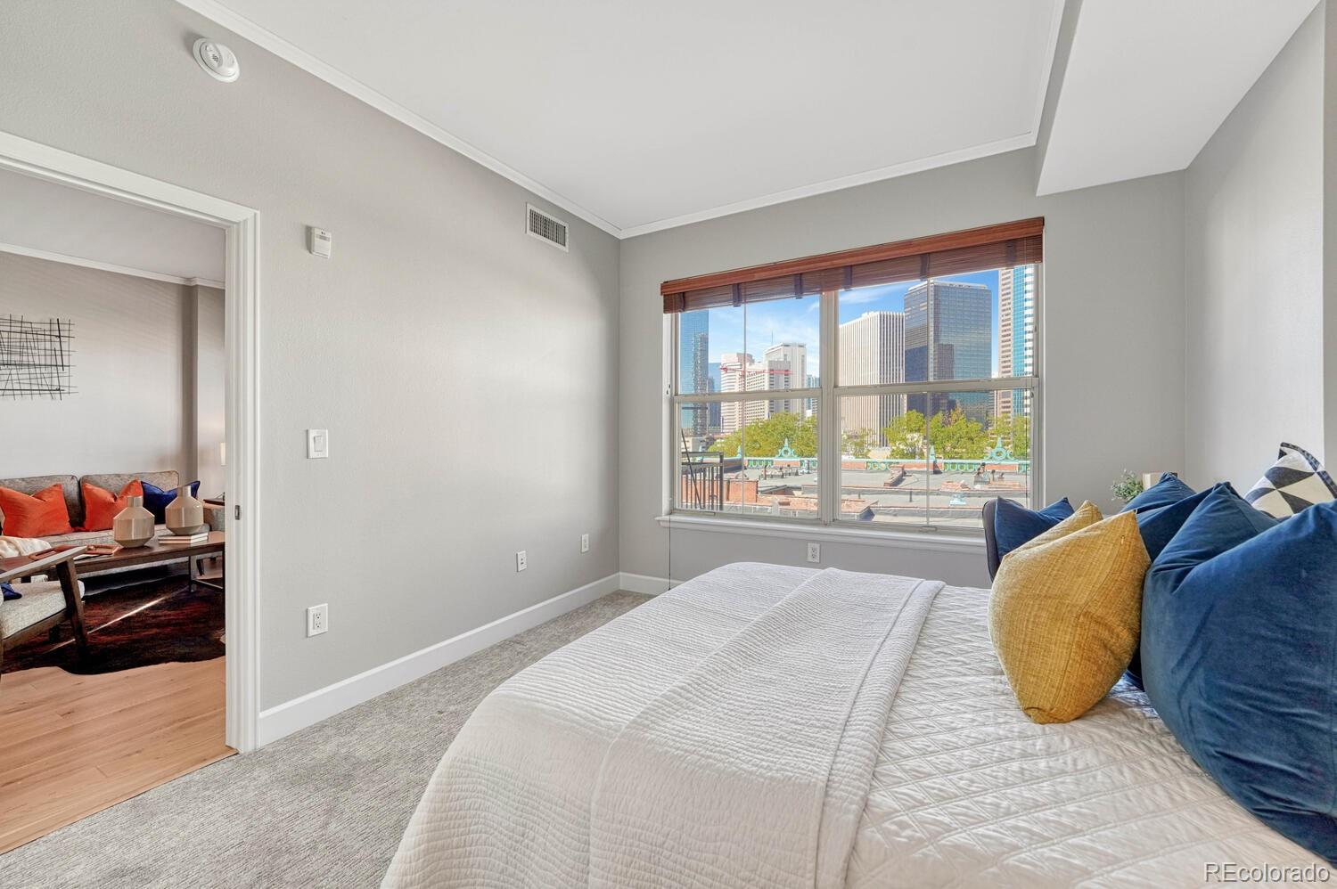 1975 Grant Street, Unit 509 Denver, CO 80203 - Photo 17 of 30 a bed sitting in a bedroom next to a window