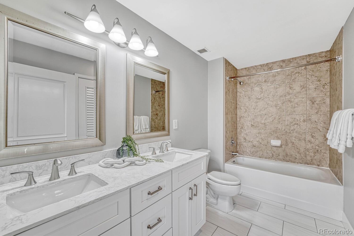1975 Grant Street, Unit 509 Denver, CO 80203 - Photo 19 of 30 a bathroom with a granite countertop sink toilet and shower