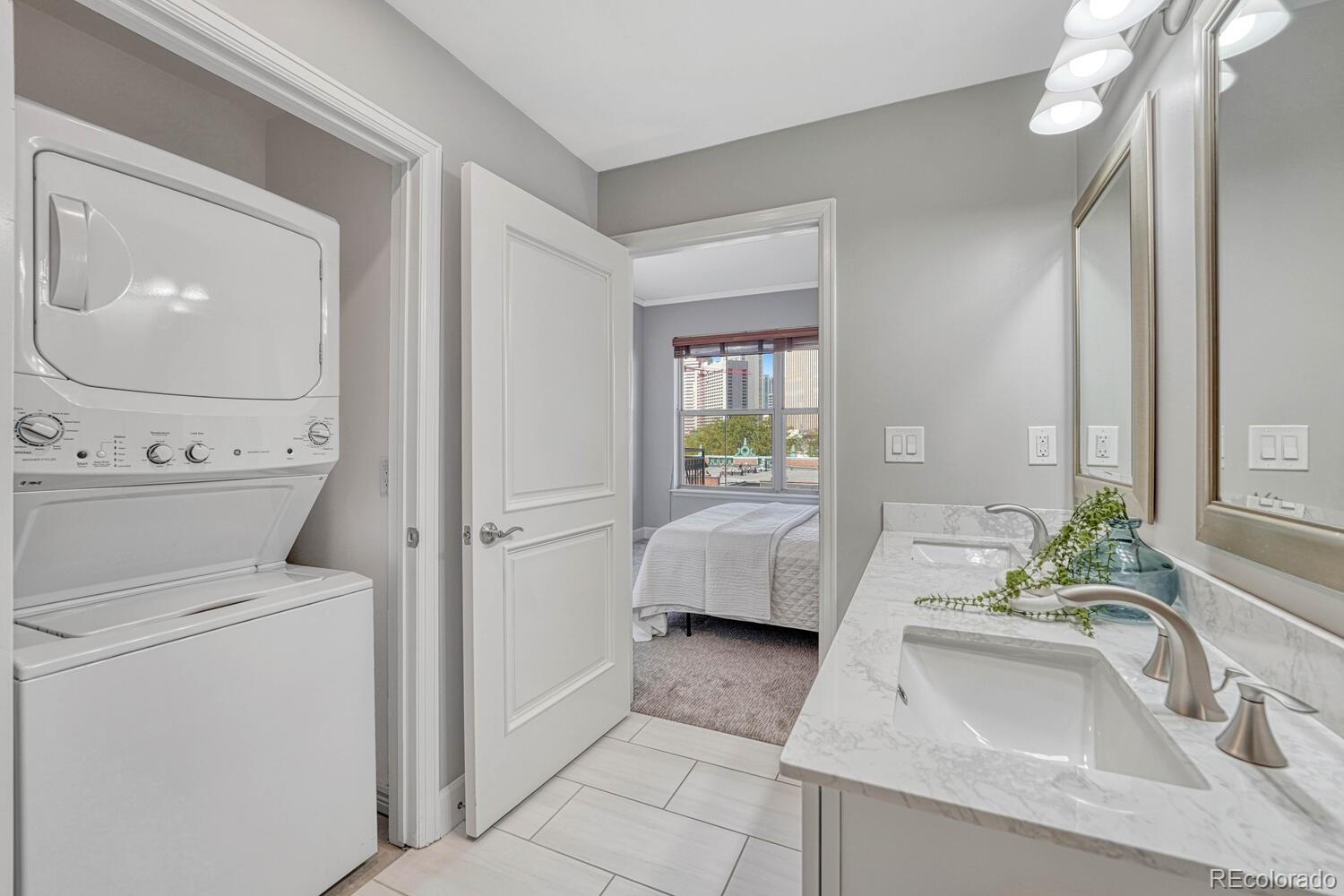 1975 Grant Street, Unit 509 Denver, CO 80203 - Photo 20 of 30 a en suite bathroom with a sink and a large mirror