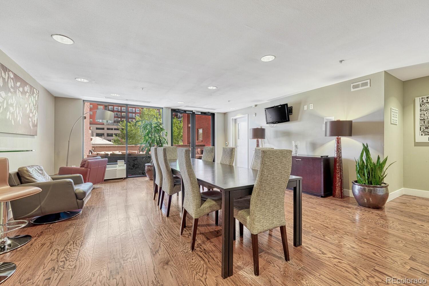 1975 Grant Street, Unit 509 Denver, CO 80203 - Photo 24 of 30 a view of a dining room with furniture window and wooden floor