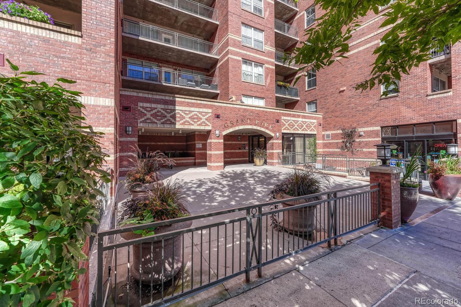 1975 Grant Street, Unit 509 Denver, CO 80203 - Photo 4 of 30 a front view of a house with a iron gate