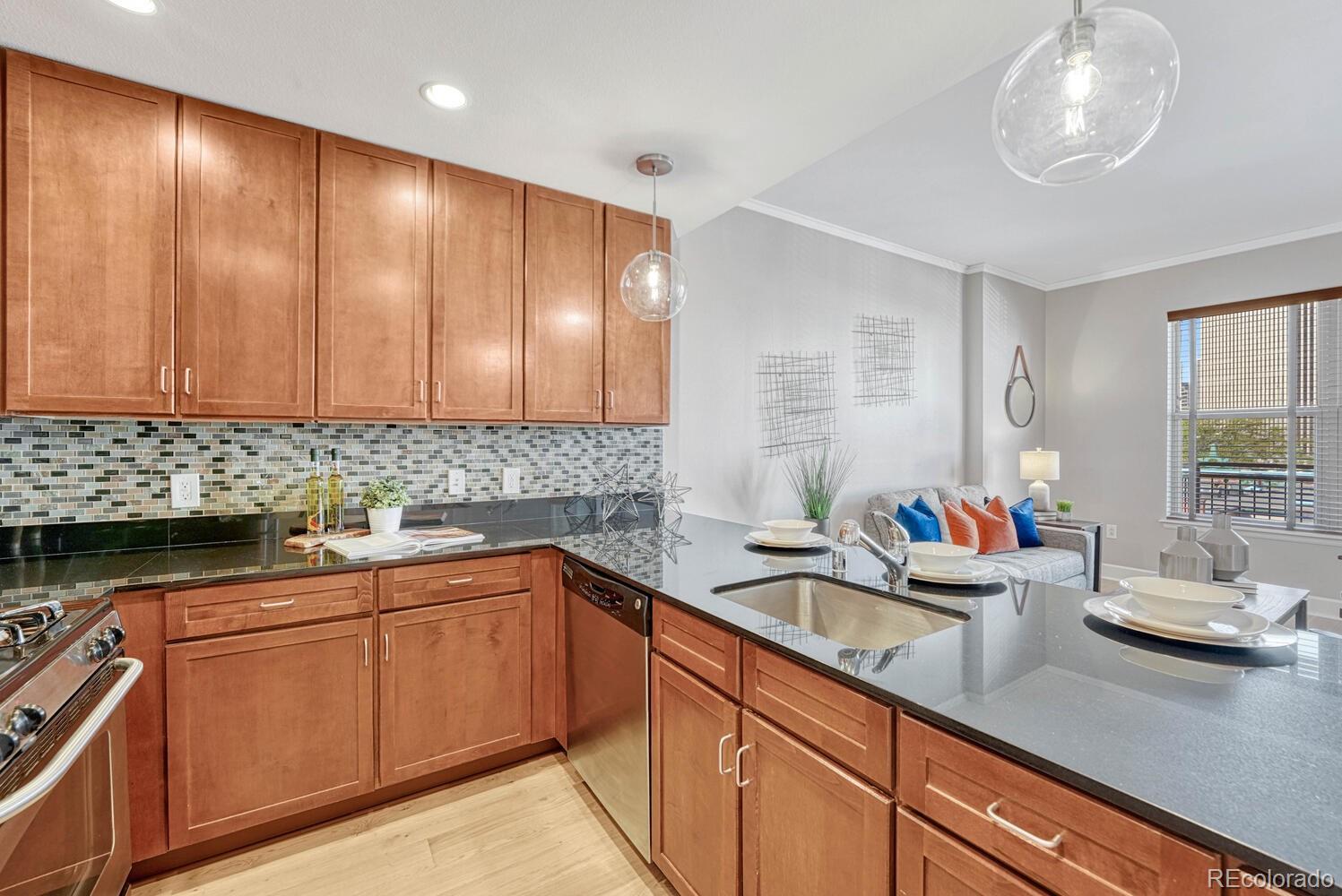 1975 Grant Street, Unit 509 Denver, CO 80203 - Photo 8 of 30 a kitchen with a sink cabinets and window