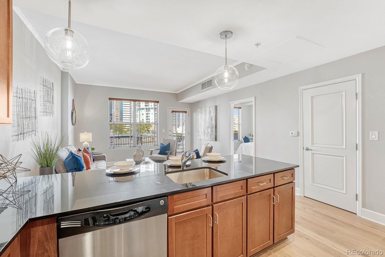 1975 Grant Street, Unit 509 Denver, CO 80203 - Photo 10 of 30 a kitchen with sink cabinets and living room view