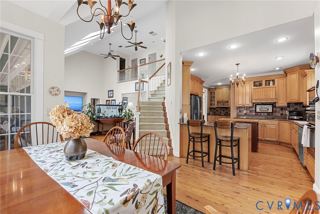13300 Old Telegraph Road Providence Forge, VA 23140 - Photo 15 of 46 a view of a dining room and livingroom with furniture wooden floor a chandelier