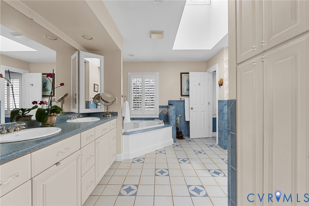 13300 Old Telegraph Road Providence Forge, VA 23140 - Photo 25 of 46 a spacious bathroom with a granite countertop sink a mirror and a bathtub