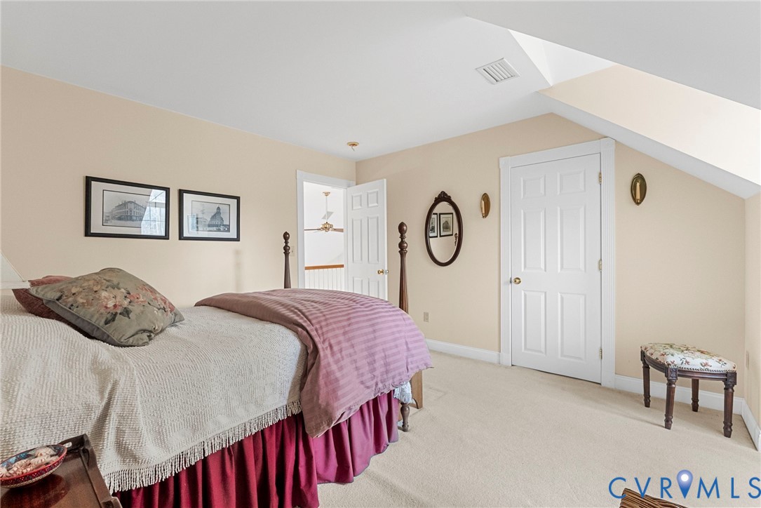 13300 Old Telegraph Road Providence Forge, VA 23140 - Photo 33 of 46 a bedroom with a bed a mirror and windows