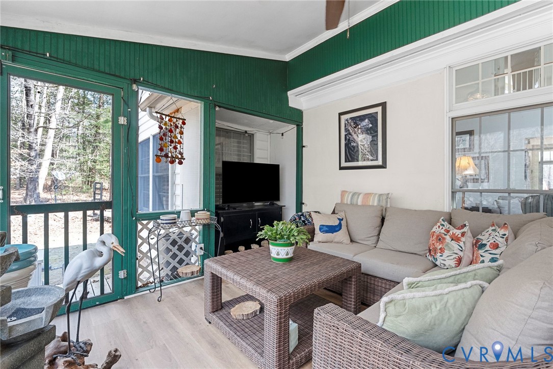 13300 Old Telegraph Road Providence Forge, VA 23140 - Photo 36 of 46 a living room with furniture a flat screen tv and a floor to ceiling window