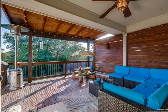 a view of a patio with couches chairs and wooden floor
