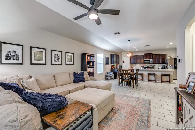 a living room with furniture and kitchen view