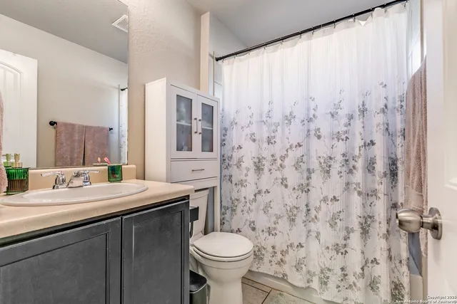 a bedroom with a bed window and a desk