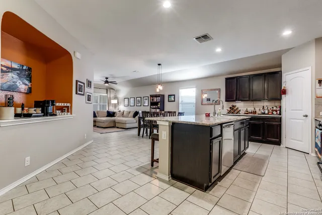 a large kitchen with stainless steel appliances lots of counter top space and cabinets