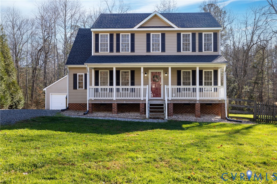 a front view of a house with a yard table and chairs