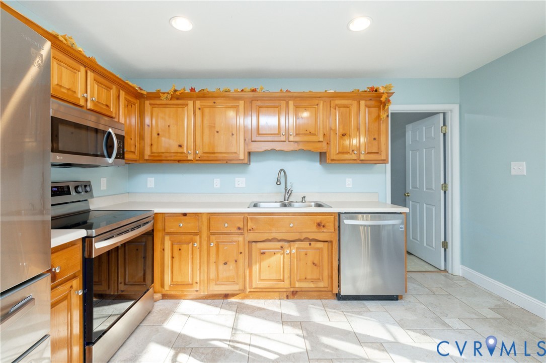15619 Devlin Drive Chesterfield, VA 23838 - Photo 14 of 46 a kitchen with stainless steel appliances granite countertop a sink and a stove