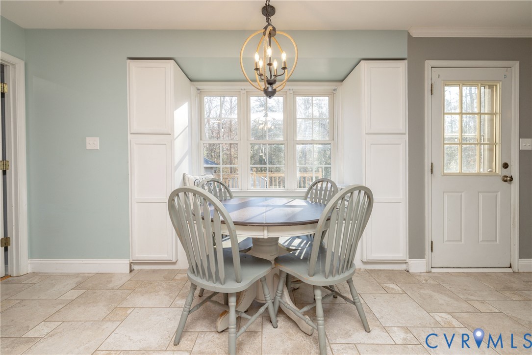 15619 Devlin Drive Chesterfield, VA 23838 - Photo 17 of 46 a view of a dining room with furniture wooden floor and chandelier