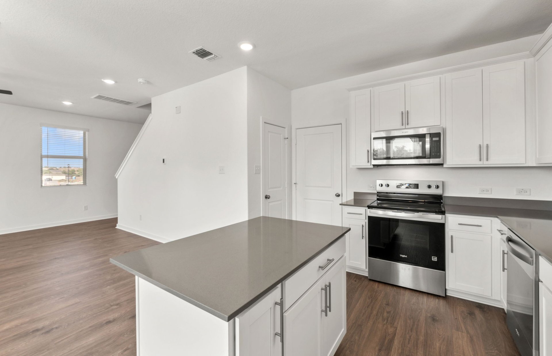 590 Rubber Tree Way Buda, TX 78610 - Photo 5 of 22 a kitchen with granite countertop a stove and a sink