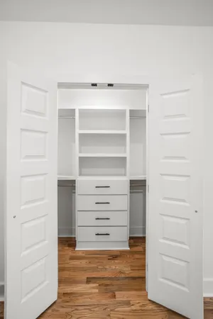 a view of walk in closet with empty racks