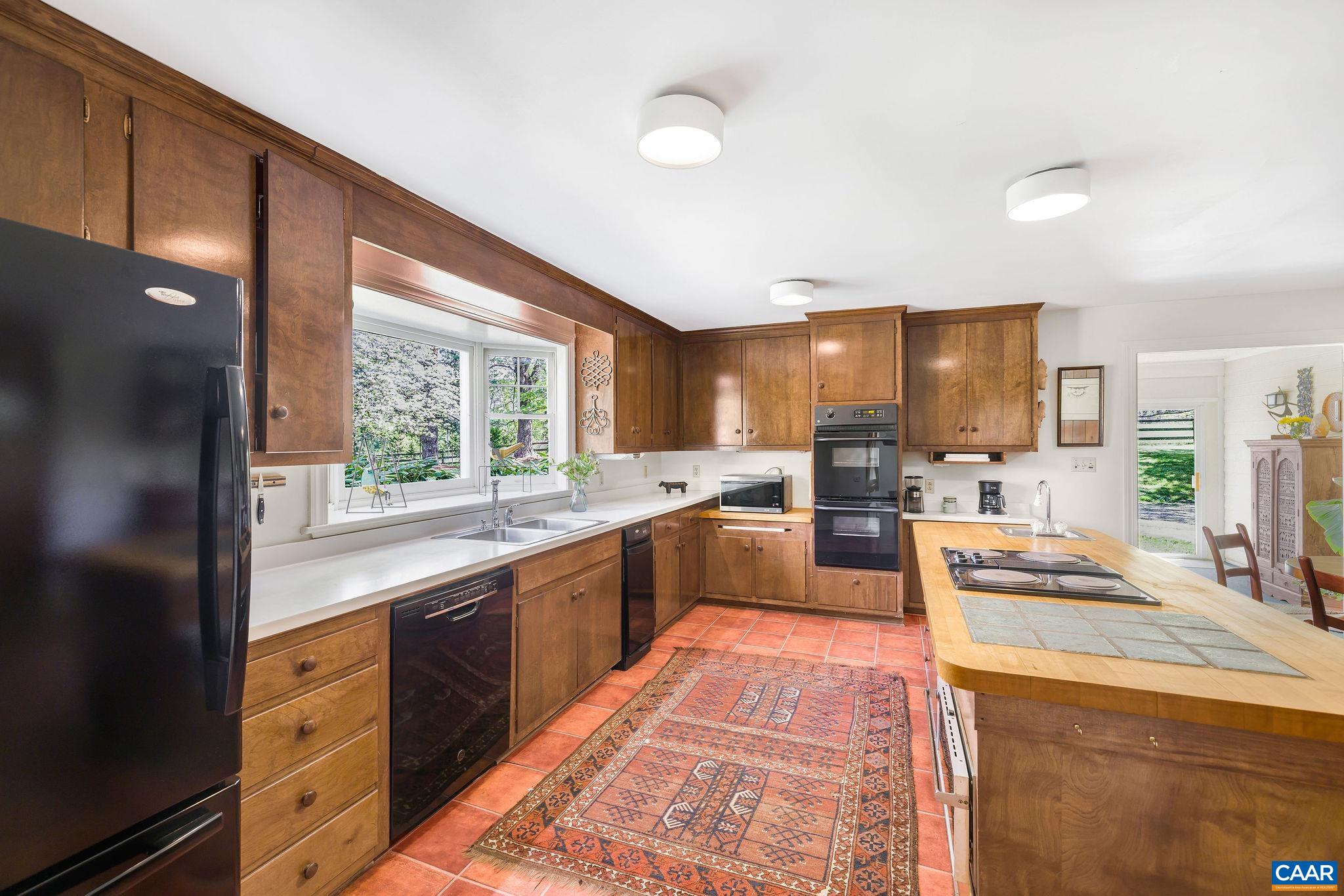 2176 Lindsay Road Gordonsville, VA 22942 - Photo 21 of 70 a large kitchen with stainless steel appliances kitchen island granite countertop a large stove top oven a sink dishwasher and cabinets with wooden floor
