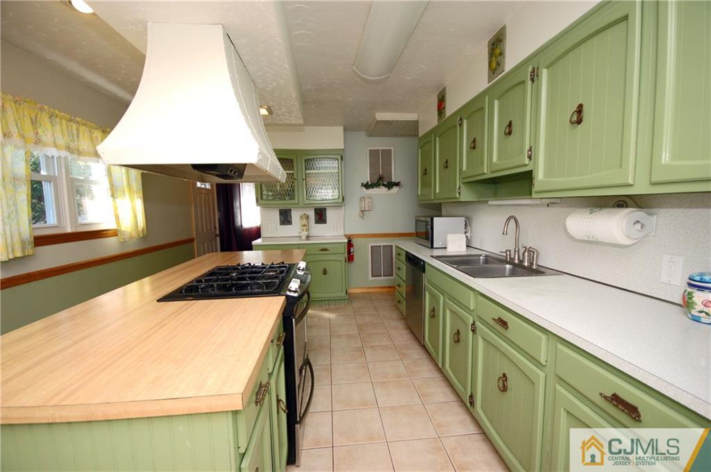 33 Stony Road Edison, NJ 08817 - Photo 12 of 25 a kitchen with stainless steel appliances granite countertop a sink and a stove