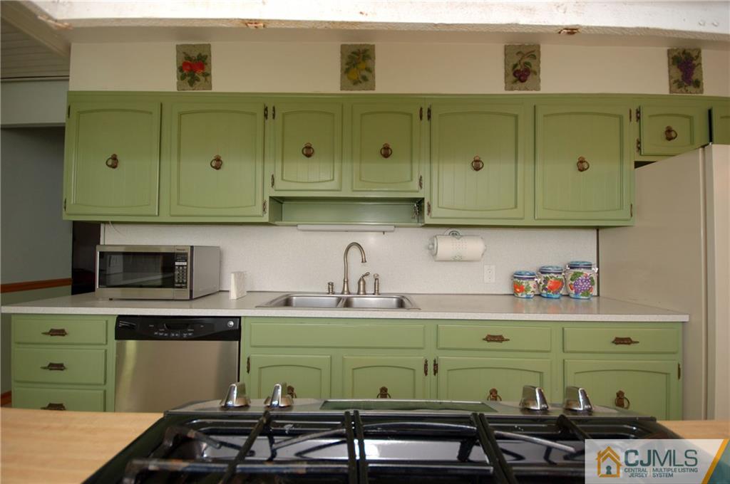 33 Stony Road Edison, NJ 08817 - Photo 14 of 25 a kitchen with a refrigerator and a cabinets