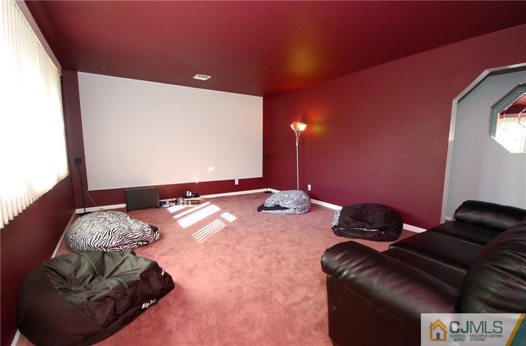 33 Stony Road Edison, NJ 08817 - Photo 19 of 25 a backyard with furniture and a projector