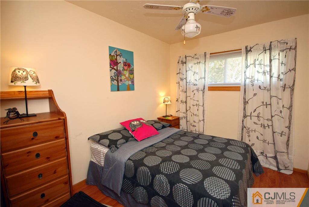 33 Stony Road Edison, NJ 08817 - Photo 3 of 25 a bedroom with a bed and a dresser