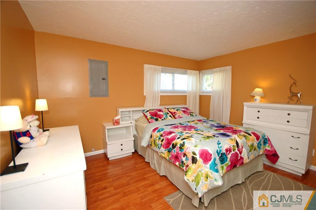 33 Stony Road Edison, NJ 08817 - Photo 21 of 25 a bedroom with a bed and a dresser